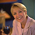 Woman smiling with a glass of red wine